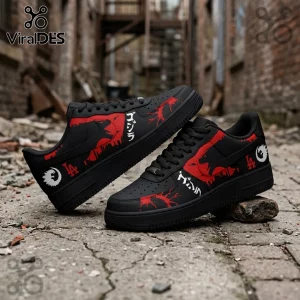 Black sneakers featuring red Godzilla silhouettes, LA logos, and white Japanese text on a textured brick background.!