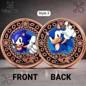 Two copper-toned Sonic the Hedgehog 35th anniversary collector coins showing front and back designs on grey surface.!