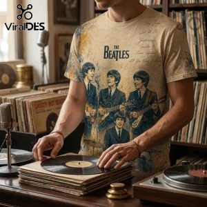 Man wearing a cream-colored t-shirt featuring The Beatles graphic, song titles, and blue watercolor splatters on cotton.!