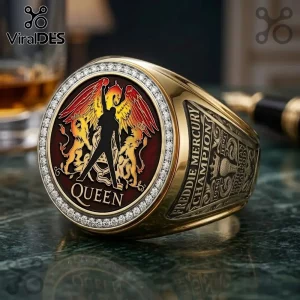 Gold ring featuring Freddie Mercury silhouette, winged lions, and Queen logo on a red enamel face with diamond bezel.!