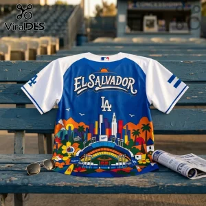 Blue and white Los Angeles baseball jersey featuring an El Salvador graphic, stadium skyline, and vibrant sun illustration.!
