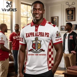 Man wearing a white polo shirt with Kappa Alpha Psi text, fraternity crest, and red checkered side panel accents.!