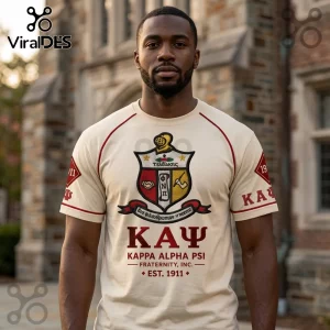 Man wearing a cream-colored Kappa Alpha Psi fraternity t-shirt with embroidered crest, Greek letters, and red trim.!