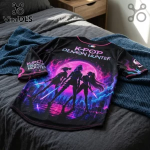 Black baseball jersey with K-POP DEMON HUNTER text, featuring a neon purple moon and three silhouettes with glowing swords.!