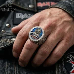 Silver tone Iron Maiden 50th anniversary ring with Eddie mascot on a blue lightning background worn on a hand.!