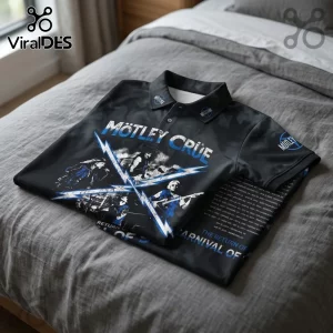 Motley Crue Carnival Of Sins 2026 Tour polo shirt in black with blue band graphics and tour dates on a gray bedspread.