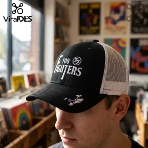 Black trucker cap with white Foo Fighters text and FF logo embroidered on the front and a small purple icon on the brim.!