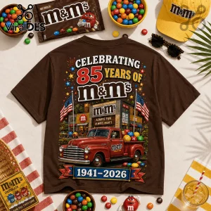 Brown t-shirt featuring 85th anniversary M&M graphics, a red vintage truck, American flags, and 1941-2026 text.!