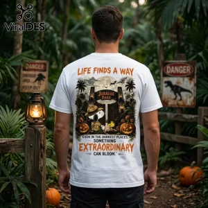 Snoopy x Jurassic Park Halloween white t-shirt featuring Snoopy in a ranger hat near the park gates and pumpkins.