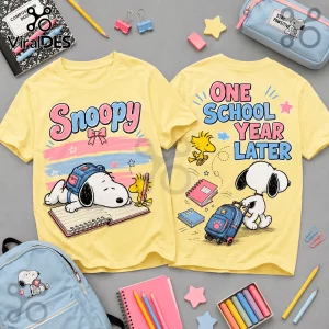 Light yellow t-shirts with front graphic of Snoopy sleeping on a notebook and back graphic stating One School Year Later.!