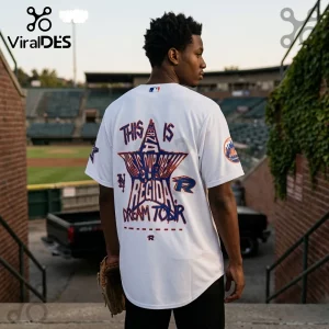Man wearing a white baseball jersey featuring a large star graphic with blue and orange text and a New York Mets logo patch.!
