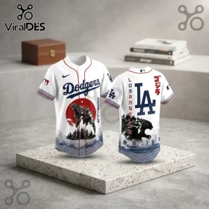 Godzilla Minus One x Los Angeles Dodgers 2026 baseball jersey with white fabric, red piping, and kaiju graphic art.