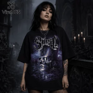 Woman wearing an oversized black Ghost band t-shirt with metallic skull and cross graphic in a dark gothic environment.!