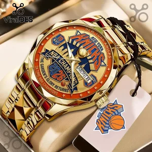 Gold-tone New York Knicks 2026 NBA Champions commemorative wristwatch with blue and orange dial and metal link strap.!