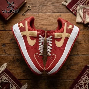 Delta Sigma Theta custom red and beige leather sneakers with gold elephant embroidery on a wooden floor background.!