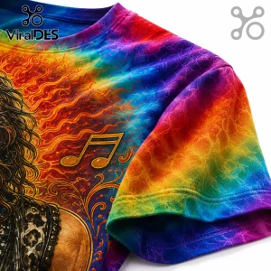 Close-up of a rainbow tie-dye t-shirt featuring a musical note graphic and a guitarist silhouette on a fire background.!