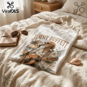 White t-shirt featuring a vintage-style graphic of Jimmy Buffett playing acoustic guitar with palm trees and floral details.!