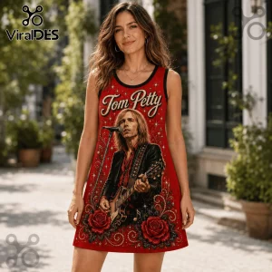 Woman wearing a sleeveless red dress with a Tom Petty graphic print, rose motifs, and gold star accents.!