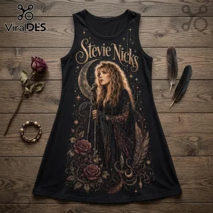 Black tank dress featuring a gold Stevie Nicks graphic with moon, roses, and star motifs on a wood surface background.!