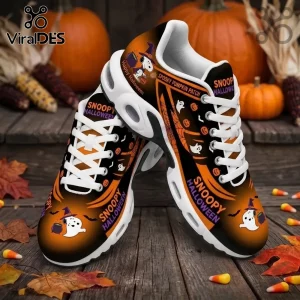 Snoopy Halloween sneakers with black and orange gradient, featuring ghost graphics, pumpkins, and white laces on wood floor.!