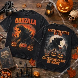 Godzilla Destroying Cities Halloween T-Shirt with double-sided monster graphic, jack-o'-lanterns, and orange text on black.