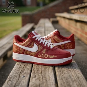 Red leather sneakers with white swooshes, gold filigree patterns, and Delta Sigma Theta lettering on wooden bleachers.!