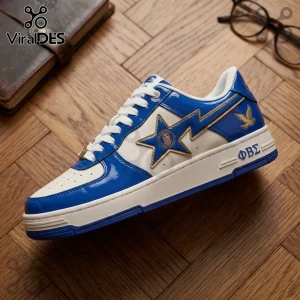 Blue and white patent leather sneaker featuring a gold star applique and Greek letters ΦΒΣ on a wooden floor background.!