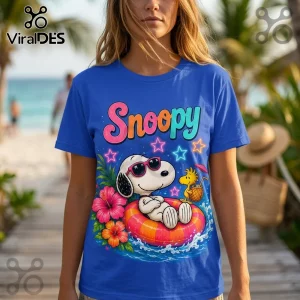 Royal blue t-shirt featuring Snoopy in pink sunglasses floating in an inner tube with Woodstock on a tropical beach background.!