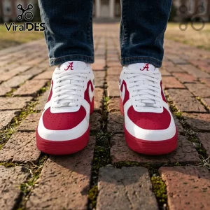 White and crimson leather sneakers with an Alabama Crimson Tide A logo on the tongue, worn with blue jeans on brick.!