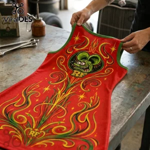 Rat Fink red tank top with green trim, yellow flame pinstripe art, and iconic rodent graphic held on a metal workbench.!