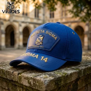 Blue wool baseball cap featuring Phi Beta Sigma fraternity logo patch and gold embroidery on a stone wall background.!