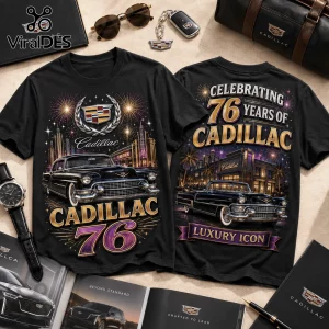 Black t-shirt featuring vintage Cadillac car graphics, city skyline, fireworks, and gold text reading 76 years of Cadillac.!