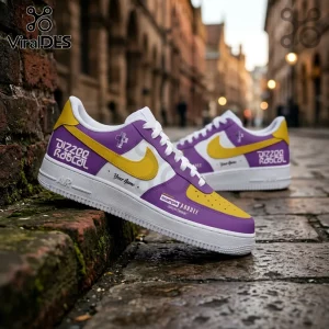 Custom purple and yellow low-top sneakers with Dizzee Rascal text, yellow swooshes, and white midsoles on cobblestones.!