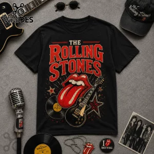 Vintage The Rolling Stones I May Be Old concert t-shirt on gray background with graphic tongue logo and red stars.