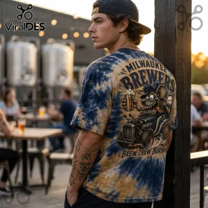 Man wearing a blue and gold tie-dye Milwaukee Brewers t-shirt featuring a cartoon rat driving a hot rod with beer.!