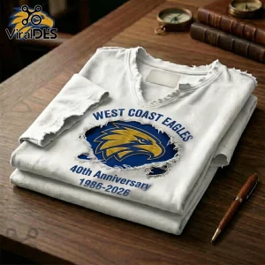 White V-neck t-shirt featuring a distressed West Coast Eagles 40th anniversary graphic with a blue and gold eagle logo.!