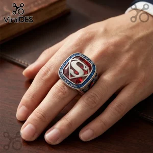 Superman Protector of Earth Engraved Ring featuring a central silver S-shield emblem set on a red stone with blue rim.
