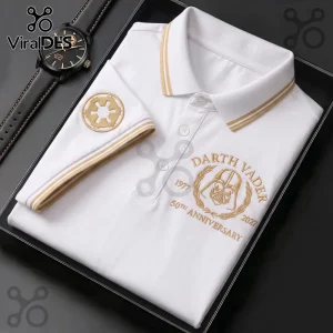 White polo shirt with gold embroidery featuring Darth Vader helmet, Imperial crest, and 50th anniversary text, next to watch.!