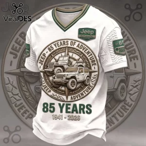 White V-neck Jeep T-shirt featuring a bronze compass graphic, Jeep vehicles, and 85 years 1941-2026 anniversary text.!