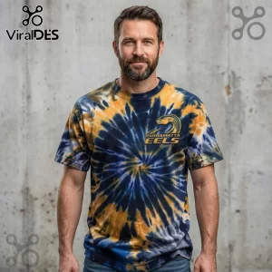 Parramatta Eels Blue and Gold Tie Dye T-Shirt worn by a man with a beard against a grey concrete wall background.