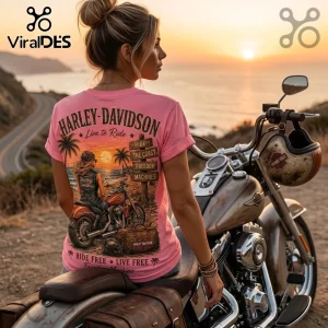 Woman wearing pink Harley-Davidson graphic t-shirt featuring coastal motorcycle sunset art on a brown cruiser motorcycle.!