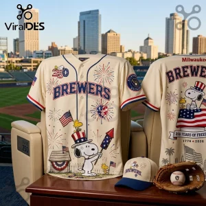 Cream-colored Milwaukee Brewers baseball jersey featuring Snoopy with an American flag, fireworks, and 250th anniversary text.!