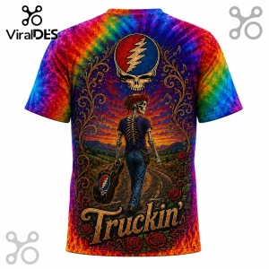 Tie-dye t-shirt featuring a skeleton walking a road with a guitar case, Steal Your Face logo, and Truckin text overlay.!