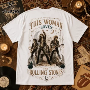 White graphic t-shirt featuring The Rolling Stones band members, star and moon illustrations, and text reading This Woman Loves.!