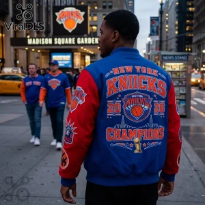 Man wearing a blue and red New York Knicks varsity jacket with championship graphics outside Madison Square Garden.!