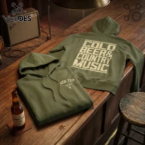 Two olive green cotton hoodies on a wooden bar with a beer bottle, reading Cold Beer & Country Music on the back.!