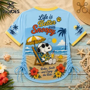 Snoopy Good Vibes Light Blue Lace-Up Jersey featuring Snoopy in sunglasses on a beach with Woodstock and tropical flowers.