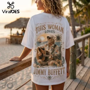 White t-shirt featuring a back print of Jimmy Buffett playing acoustic guitar on a beach at sunset with tropical foliage.!
