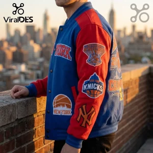 Blue and red New York Knicks varsity jacket with embroidered basketball team logos against a blurred city skyline background.!