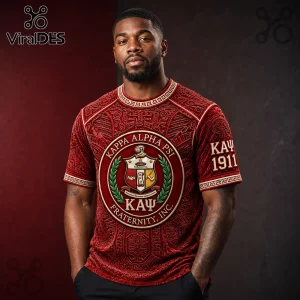 Man wearing a red velvet Kappa Alpha Psi t-shirt with a gold crest, greek lettering, and 1911 print on the sleeve.!